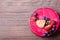 Delicious raspberry cake with fresh strawberries, raspberries, blueberry, currants and pistachios on wooden background