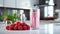 Delicious raspberry milkshake in clear glass on white kitchen counter with bright sunlight