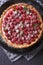 Delicious raspberry tart with whipped cream vertical top view cl