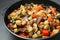 Delicious ratatouille in baking dish on grey table, closeup