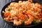 delicious recipe for Italian pasta with squid, tiger shrimps, vegetables, parmesan cheese and tomato sauce close-up. horizontal