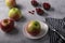 Delicious red apples, a knife prepared for cutting an apple, small bowls with dried cranberries.