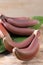 Delicious red baby bananas on wooden table
