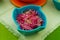 Delicious red fresh onion inside of a magenta bowl, useful for prepare many ecuadorian dishes