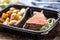 Delicious red meat sous vide steak packed in portable take away plastic box and served with crunchy roasted potatoes and savory