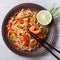 Delicious rice noodles with shrimp and vegetables top view