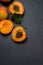 Delicious ripe apricots on black shale background