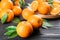 Delicious ripe oranges on black wooden table