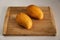 Delicious ripe yellow mangos on white table