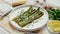 Delicious roasted asparagus served on white ceramic plate. With parmesan cheese, parsley and lemon.