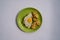 Delicious roasted cauliflower steak with basted egg  served on a green plate, top view