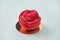A delicious rose-shaped cake with a red velvet texture on a white textural background. Stylish dessert pastries
