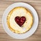 Delicious round cheesecake with raspberry heart, sweet food