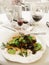 delicious salad caesar on luxury plate and wine, gorgeous catering in restaurant