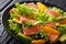 Delicious salad of salted salmon, oranges, avocado and frisee cl