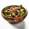 Delicious salad sitting in wooden bowl against neutral white background