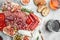 delicious salami, pieces of sliced prosciutto crudo, sausage and wine. Meat platter. Mixed delicatessen of meat snacks. place for