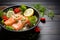 Delicious salmon salad bowl, showcasing raw sashimi, lemon, and spices