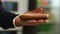 Delicious sausage sandwich. Stock footage. Close-up of man\'s hand holding a piece of Borodino rye bread with slice of