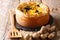 Delicious savory pie with wild mushrooms, cheddar cheese, chicken and cream close-up. horizontal