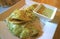 Delicious Savory Spinach Crepes with Green Mustard Sauce on the White Plate