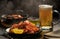 Delicious scene with steaming plate of hot fried shrimps and glass of beer