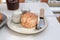 Delicious scones with Strawberry Jam and Clotted Cream on white table.