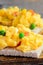 Delicious scrambled eggs with vegetables on crispy toast. Scrambled omelette toast recipe. Simple homemade cooking. Vertical photo