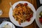 Delicious seafood spaghetti pasta with mussel, squid, shrimp, tomato sauce, etc. serve on white dish