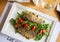 Delicious seared fish fillet with wine on restaurant background