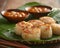 Delicious Seared Scallops on Bamboo Mat with Side Sauces and Chopped Garlic in Rustic Kitchen Setting