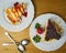 Delicious Set of cheesecakes with a Strawberry, Strawberry sauce drip, crumbled cookies and two spoons on wooden background. Top