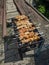 Delicious shish kebab is prepared on an old black grill in Kamen-na-Obi, Altai, Russia. Vertical