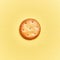 Delicious single salty biscuit over isolated yellow background