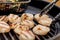 Delicious sizzling sea scallops grilling on a charcoal grill