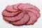 Delicious sliced salami on a white background