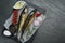 Delicious smoked mackerels and products on gray table, top view. Space for text
