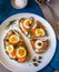 Delicious smoked salmon sourdough toast with goat cream cheese and cut boiled egg, garnished with dill, chives & pickled Capers