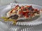 A delicious snack of pickled Mediterranean horse mackerel  Trachurus with garlic and hot red pepper in Greece