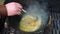 Delicious soup boiling in pot mixing with steel spoon. Handheld slow motion