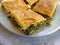 Delicious `spanakopita` traditional Greek spinach and feta pie portions