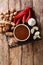 Delicious spicy tamarind sauce closeup in a bowl on a table. Vertical top view