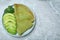 Delicious spinach crepes with avocado on table, top view. Space for text