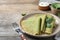 Delicious spinach crepes served on table