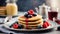 Delicious stack of pancakes close-up with fresh blueberry and raspberry