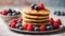Delicious stack of pancakes close-up with fresh blueberry and raspberry