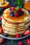 Delicious stack of pancakes with fresh berries and a generous drizzle of honey on a plate