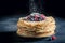 Delicious stack of pancakes with fresh berries and mint