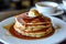 Delicious stack of pancakes with syrup and butter on top