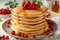 Delicious stack of pancakes topped with fresh berries and drizzled honey on a plate